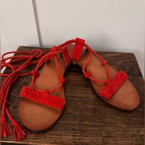 Frye size 8 orange leather lace up sandals with ankle ties with tassels.